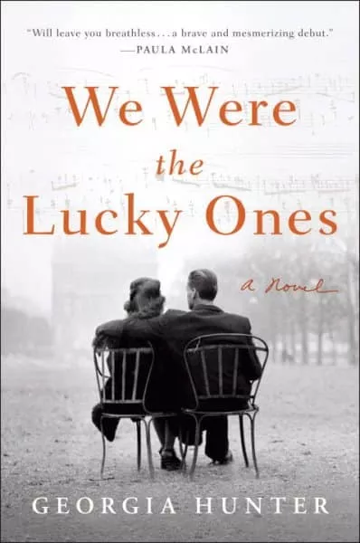 Book cover for 'We Were the Lucky Ones' by Georgia Hunter, featuring a couple sitting in chairs facing away from the viewer.