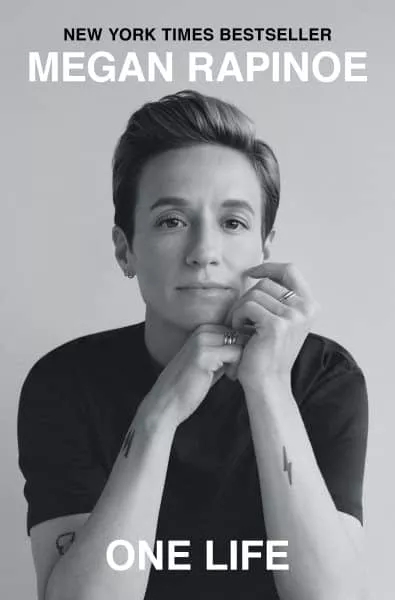 Book cover for "One Life" by Megan Rapinoe, a New York Times Bestseller. Features a black and white portrait of the author.