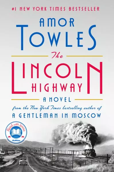 The Lincoln Highway by Amor Towles, a #1 New York Times bestseller. Features a vintage car on a highway with a steam train